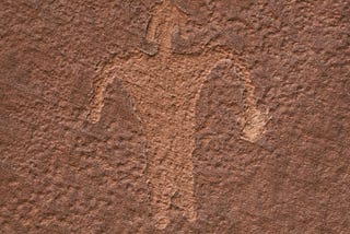 Petroglyph of a figure with unusual headgear