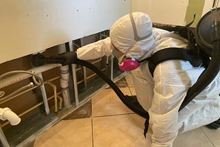 Rapid_Restoration_Recovery_Inc-Tech-in-hasmat-suite-cleans-mold