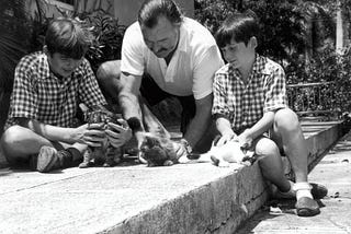 Hemingway with sons Patrick and Gregory and kittens. From the Ernest Hemingway Photograph collection: John F. Kennedy Presidential Library.