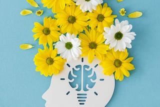 White paper head with yellow and white flowers flourishing