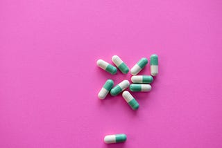 Image of pills on a pink background