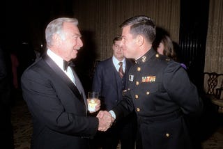 A Marine Corps major shaking hands with Walter Cronkite