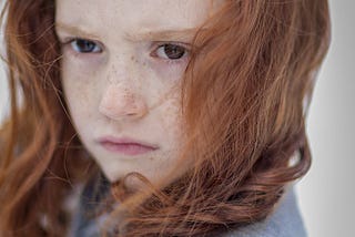 Female child with ginger hair and freckles
