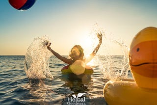 Happy person floating on a water float in summer