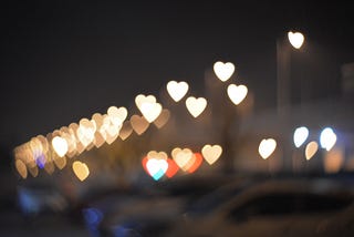 Beautiful image of hearts lit up against a black background.