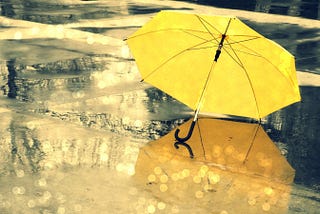 A yellow umbrella on an empty street — already a powerful image.