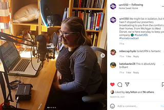 A Girl sits in-front of a microphone with her computer next to her to indicating that she is recording for University Radio Nottingham whose Instagram post it it within.