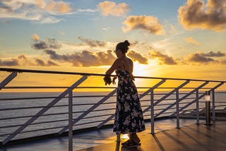 A lady in a summer dress watching a beautiful golden sunset. Nature always makes you feel like you’ll be okay.