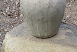 Ancient vessel with a piece of paper that reads ‘ truth is a pathless land’