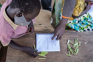 An early primary school learner in Uganda during a Community-Led Learning class.