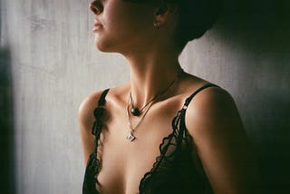 Woman cropped from eyes to chest, wearing strappy dress. Image for post on sexual assault awareness month by Valicia France.