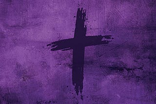 Cross in black ashes against a purple background, symbolizing Lent.