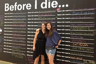 the author and her friend Megan stand in front of a college dream board