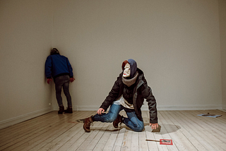 Image of Mia Habib’s dance performance Stranger Within shows two masked dancers in a white room.