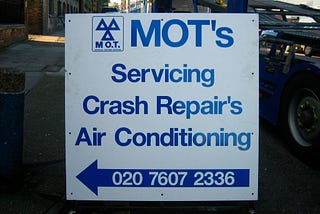 Garage sign containing inappropriate apostrophes.