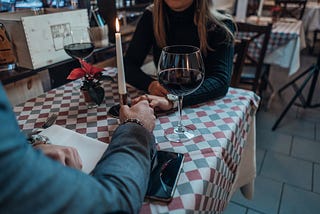 romantic dinner holding hands — Photo by René Ranisch on Unsplash