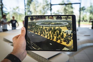 Someone looking through a tablet at an AR experience.