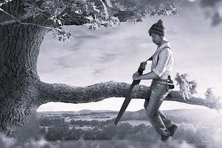 Picture of a man looking blissfully unaware while sawing off the branch of a tree as he’s sitting on the end that will fall to the ground.