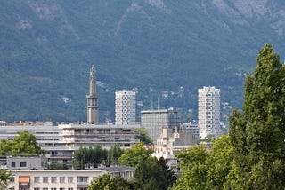 View of the skyline of the city of Grenoble, France, with greenery in the foreground