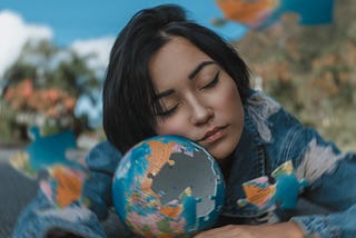 Woman in Blue and White Floral Long Sleeve Shirt Holding A Round Shaped Puzzle and sleeping.