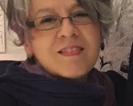 A photograph of the author smiling