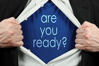 white shirt opening to undershirt reading “are you ready?”