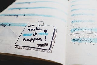 Page of a diary showing an image that reads ‘make it happen’