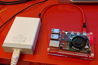 A Raspberry Pi 4 on a desk plugged into a power supply