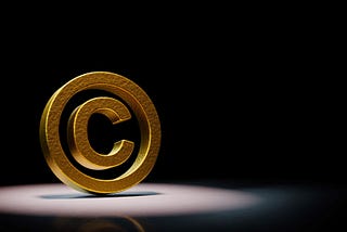 A golden copyright symbol in the spotlight