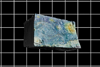 a large limestone block floats above a black background with a white grid. Van Gogh’s ‘The Starry Night’ is projected on the front.