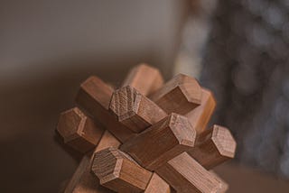 A wooden rubics cube on a table