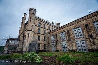 A gothic castle-like limestone structure with turrets and a gloomy sky.