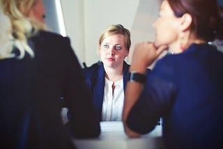 woman in between two other women listening intently