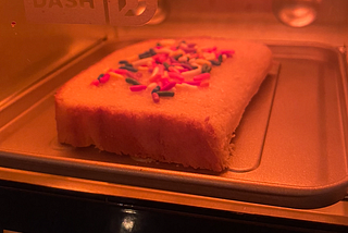 Rainbow sprinkle toast under the warm glow of a Dash Mini Toaster Oven