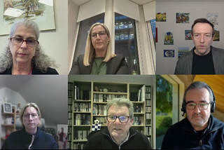 Virtual panel discussion with six participants in a grid layout. Top row: Debra (gray hair, glasses, serious), Kat (blonde, glasses, speaking), Neil (short brown hair, blazer, artwork behind). Bottom row: Emily (blonde, glasses, home office), Mark (glasses, bookshelf), Antonio (dark hair, headphones, window with greenery