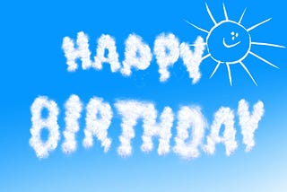 A bright blue sky is the backdrop for “Happy Birthday” written in cloud letters. In the upper right corner is a childishly drawn, smiley-faced white sun outline.