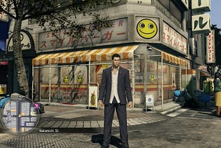 Yakuza 0: Director’s Cut protagonist Kiryu stands in front of a shop called Smile Burger on a busy day in the city.