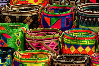 multiple colorful with distinct geometric patterns baskets lined up in rows