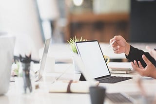 Two HR rep hands wave about in front of a computer as they try to determine what to do and what not do in regard to employee engagement.
