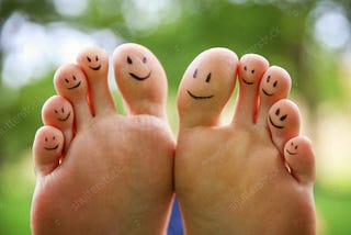 ten toes with smiley faces on each one