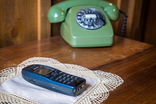 Cordless phone and vintage rotary phone side by side on a table — symbolizing memory, trauma, and healing in EMDR therapy in this story.