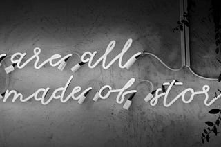 LED on a wall that says “We are all made of stories”