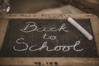 Back to school written on a chalkboard.