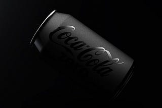 A black matte coca cola can with glossy logo