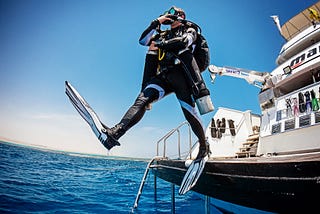 scuba diver ready to dive in sea from boat