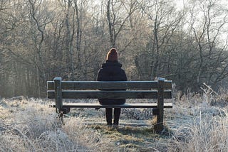 Person sitting alone on a bench