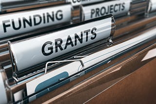 File folders in a drawer with tabs labeled GRANTS, FUNDING and PROJECTS.