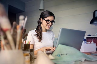 A woman preparing a presentation on her laptop.