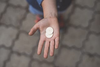 Person holding 2 coins
