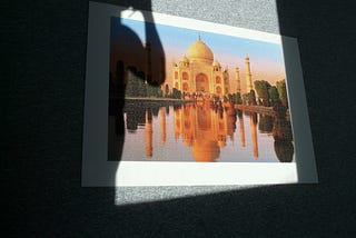 Someone is taking a picture of a puzzle of the Taj Mahal